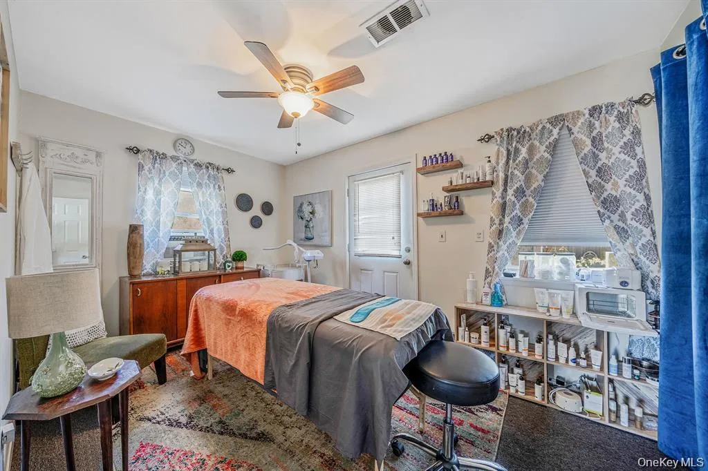 Bedroom with multiple windows, ceiling fan, and carpet floors Bedroom with multiple windows, ceiling fan, and carpet floors