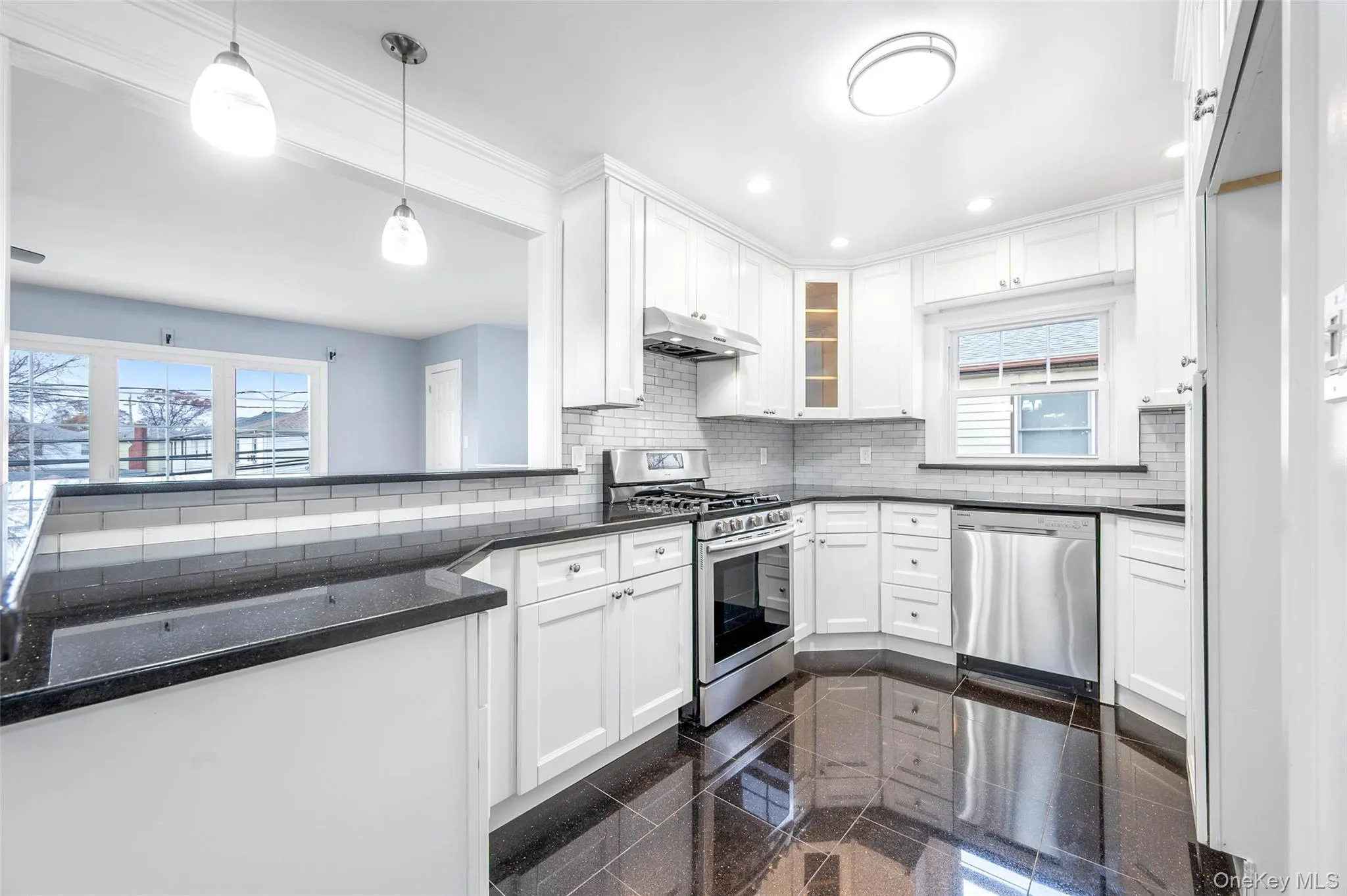 Kitchen featuring granite tiled floors, stainless steel appliances, white cabinets, healthy amount of natural light, and recessed lighting Kitchen featuring granite tiled floors, stainless steel appliances, white cabinets, healthy amount of natural light, and recessed lighting