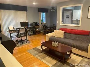 Living room featuring a desk and light wood-style floors Living room featuring a desk and light wood-style floors