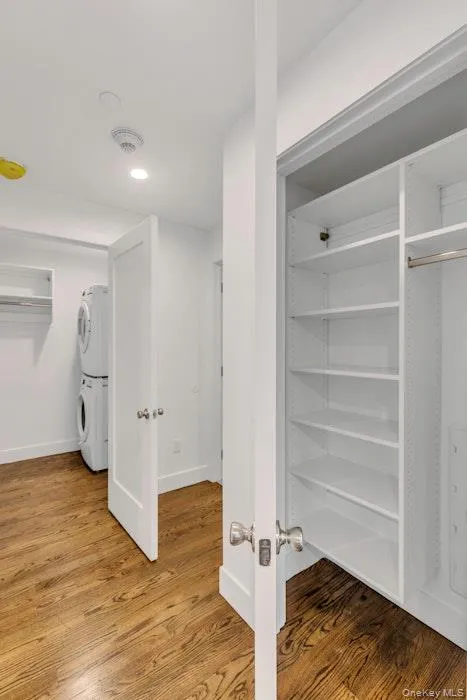 Closet featuring stacked washer/dryer and built-ins Closet featuring stacked washer/dryer and built-ins