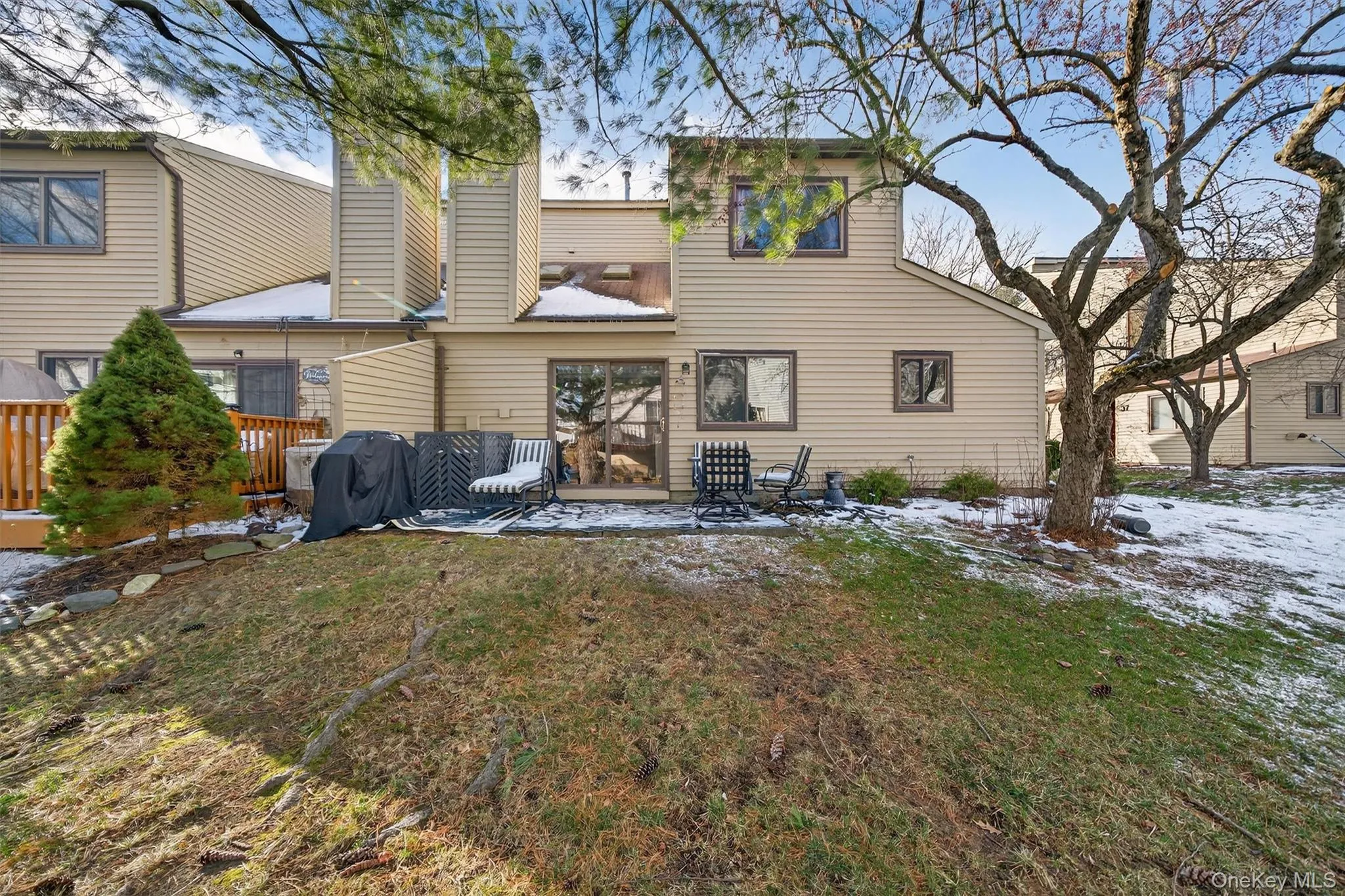 Back of house featuring a patio area and a lawn Back of house featuring a patio area and a lawn