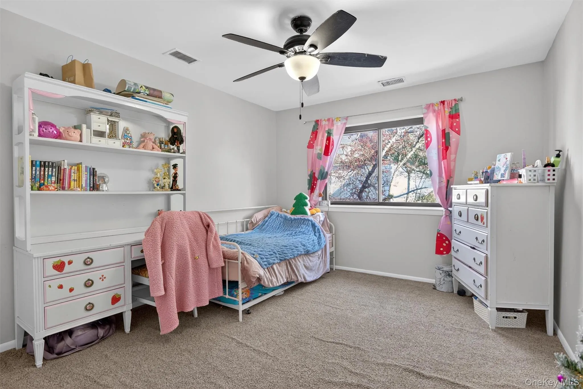 Bedroom featuring light carpet and a ceiling fan Bedroom featuring light carpet and a ceiling fan