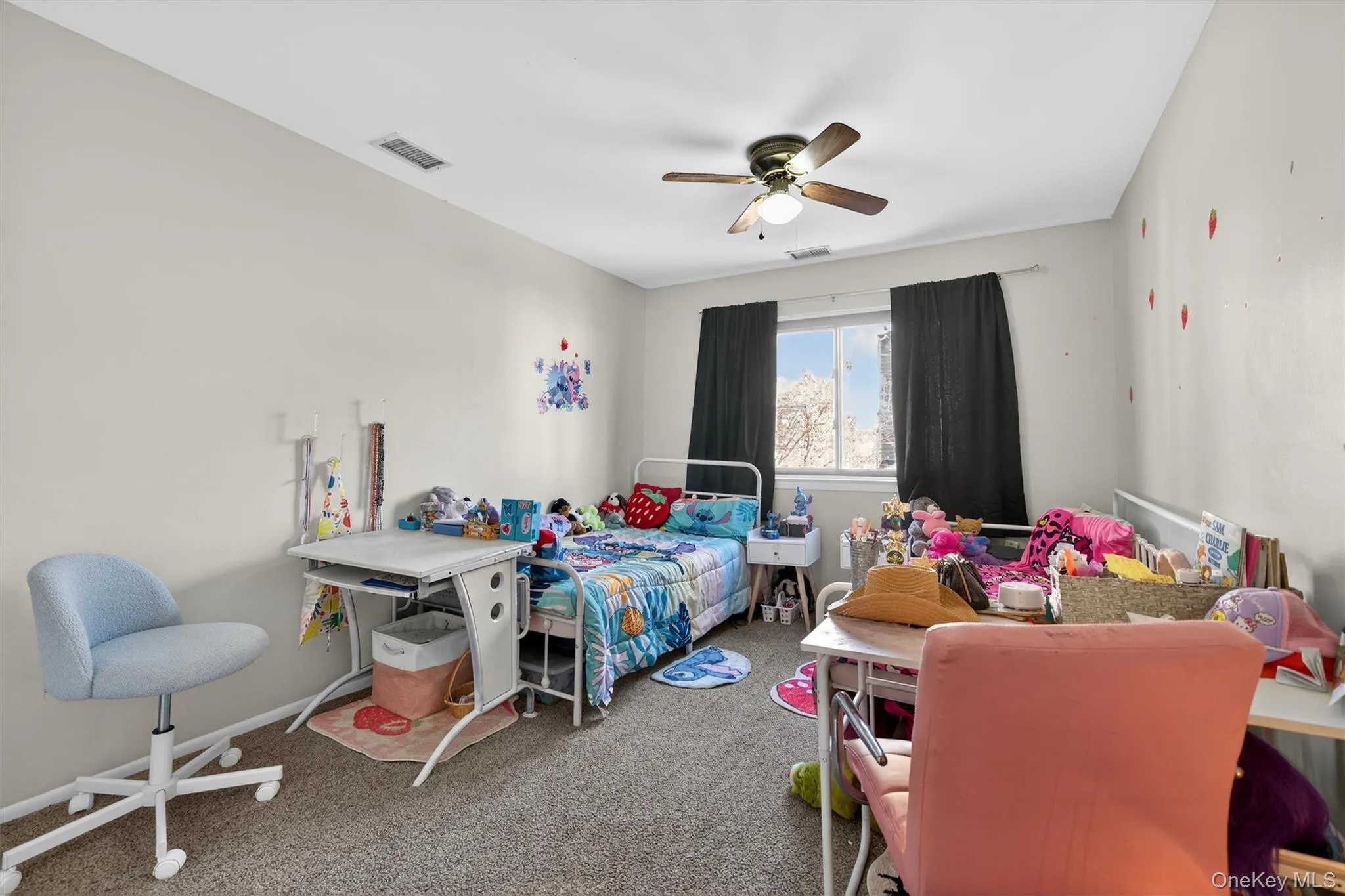 Carpeted bedroom with a ceiling fan and baseboards Carpeted bedroom with a ceiling fan and baseboards
