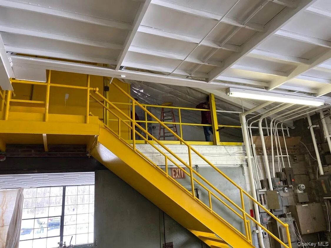 Steel mezzanine access with dedicated stair system.Elevated office / storage component maximizing vertical utility. Steel mezzanine access with dedicated stair system.Elevated office / storage component maximizing vertical utility.