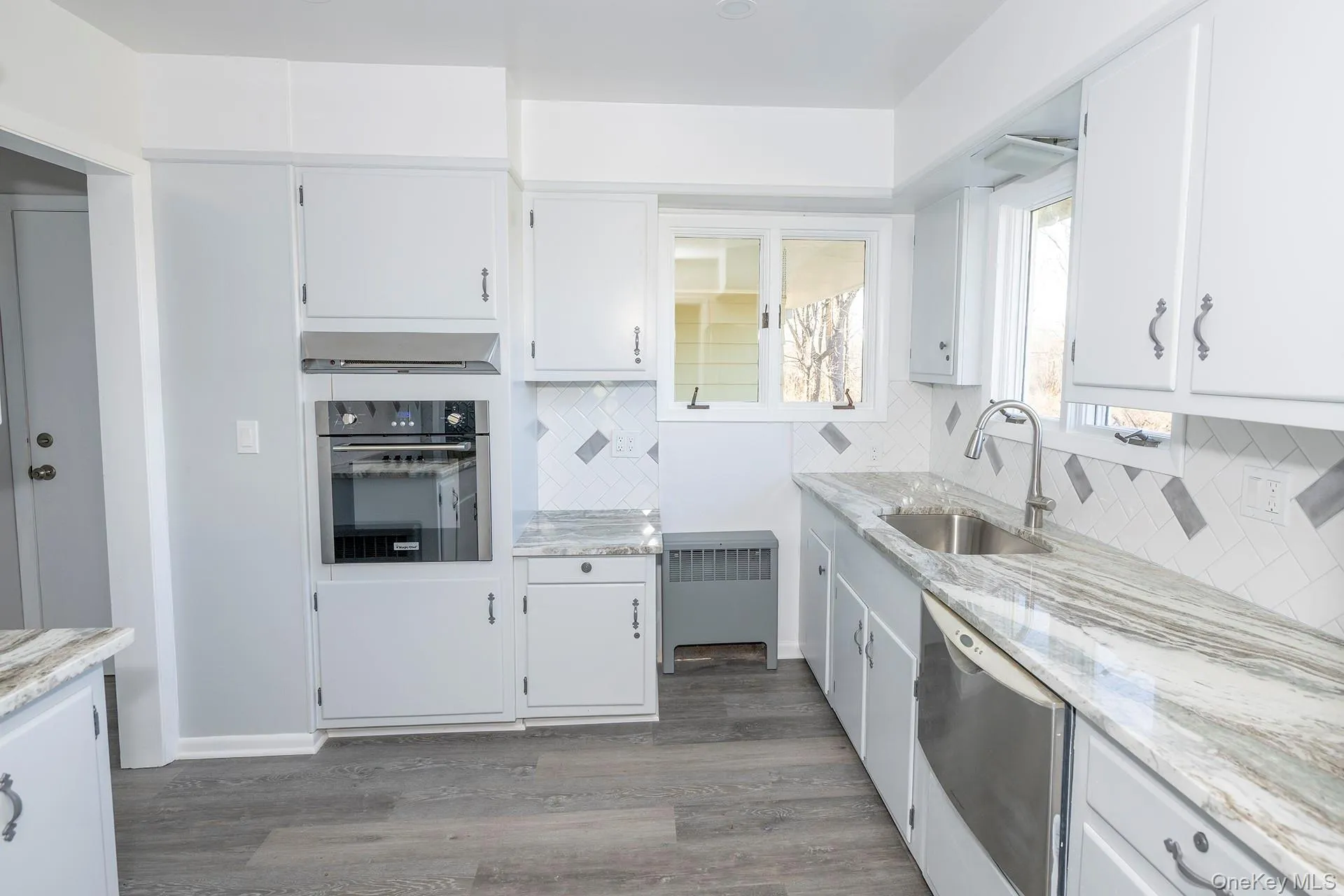 Kitchen with white cabinets and new flooring Kitchen with white cabinets and new flooring
