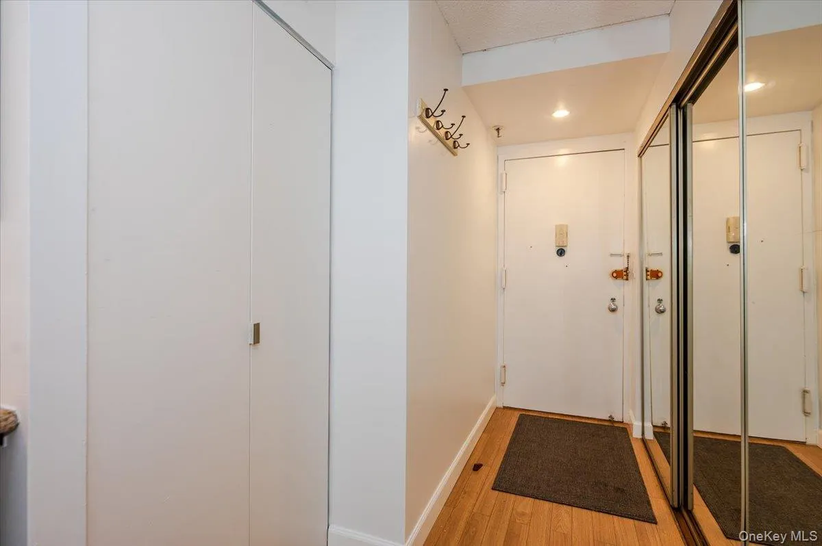 Hallway with light wood-type flooring and baseboards Hallway with light wood-type flooring and baseboards