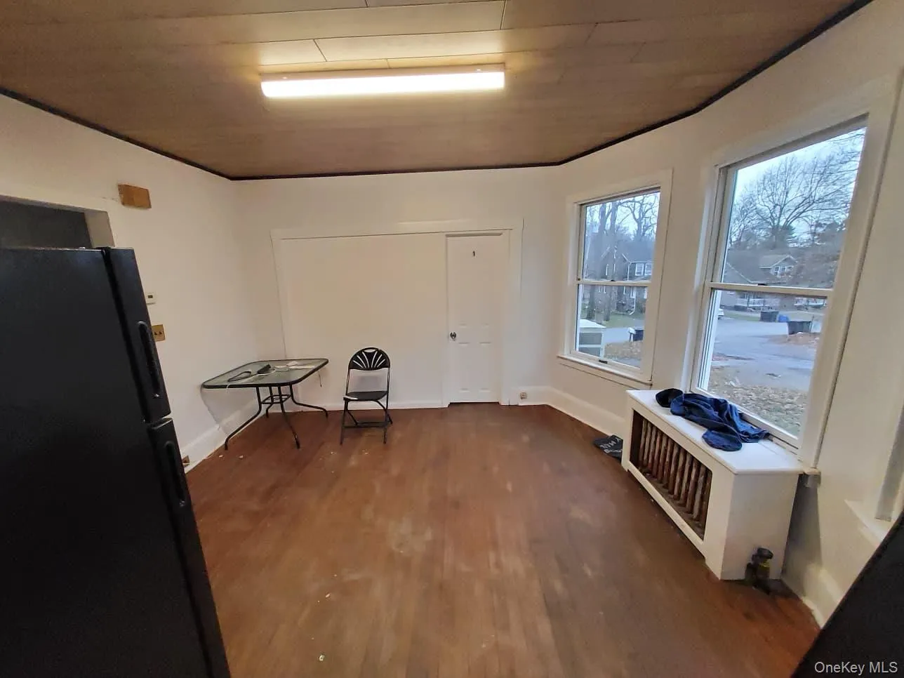 Sitting room featuring dark wood-style flooring and radiator Sitting room featuring dark wood-style flooring and radiator
