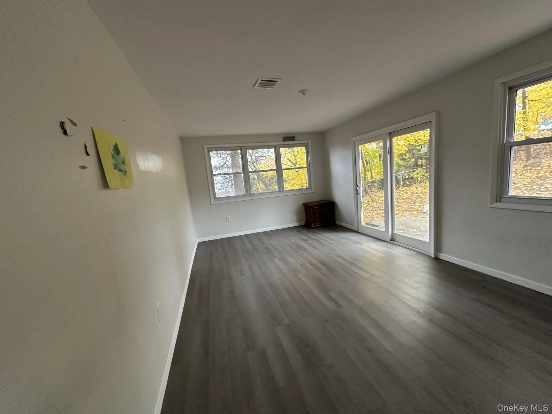 Spare room featuring baseboards and wood finished floors Spare room featuring baseboards and wood finished floors