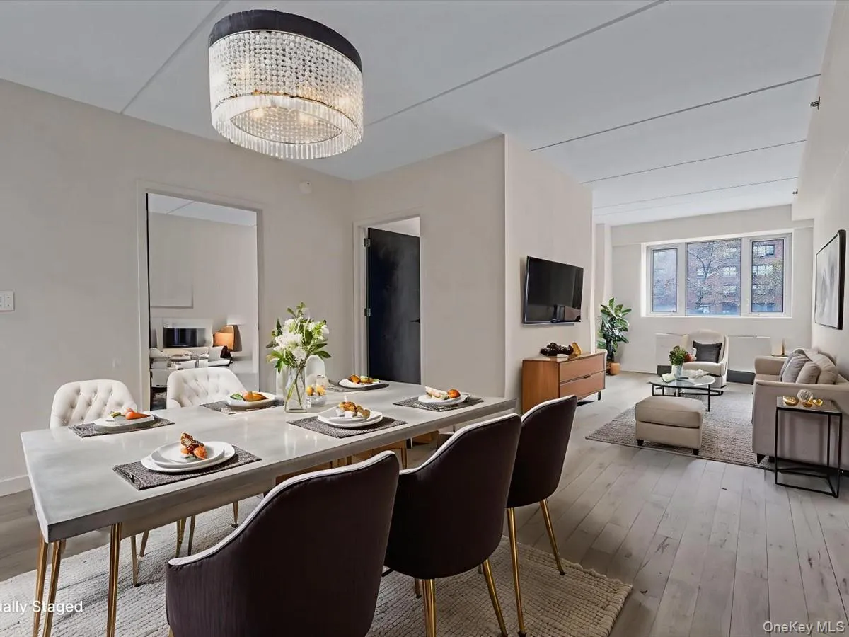 Dining space with light wood-type flooring and a chandelier Dining space with light wood-type flooring and a chandelier