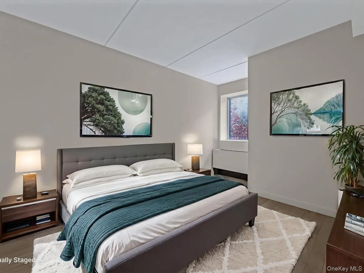 Bedroom featuring wood finished floors and baseboards Bedroom featuring wood finished floors and baseboards