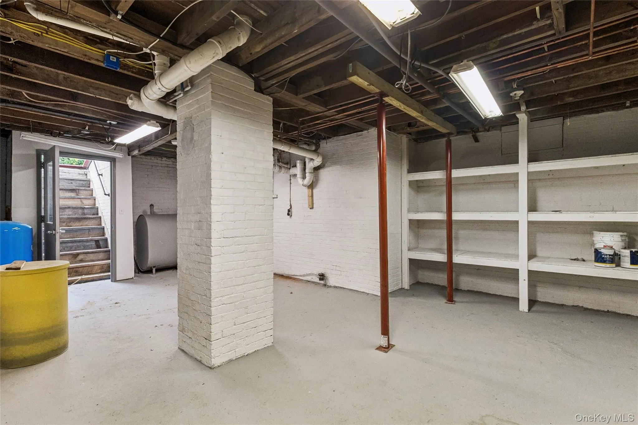 Unfinished below grade area with oil tank and a water pressure tank Unfinished below grade area with oil tank and a water pressure tank