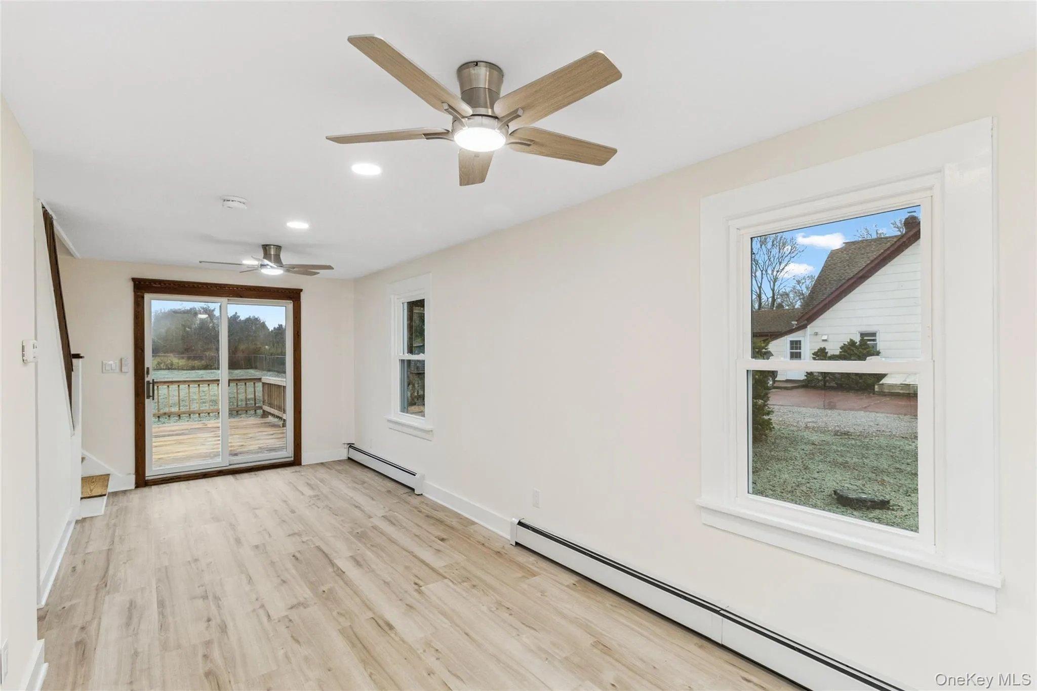 Unfurnished room with a baseboard heating unit, light wood-style flooring, recessed lighting, and a ceiling fan Unfurnished room with a baseboard heating unit, light wood-style flooring, recessed lighting, and a ceiling fan
