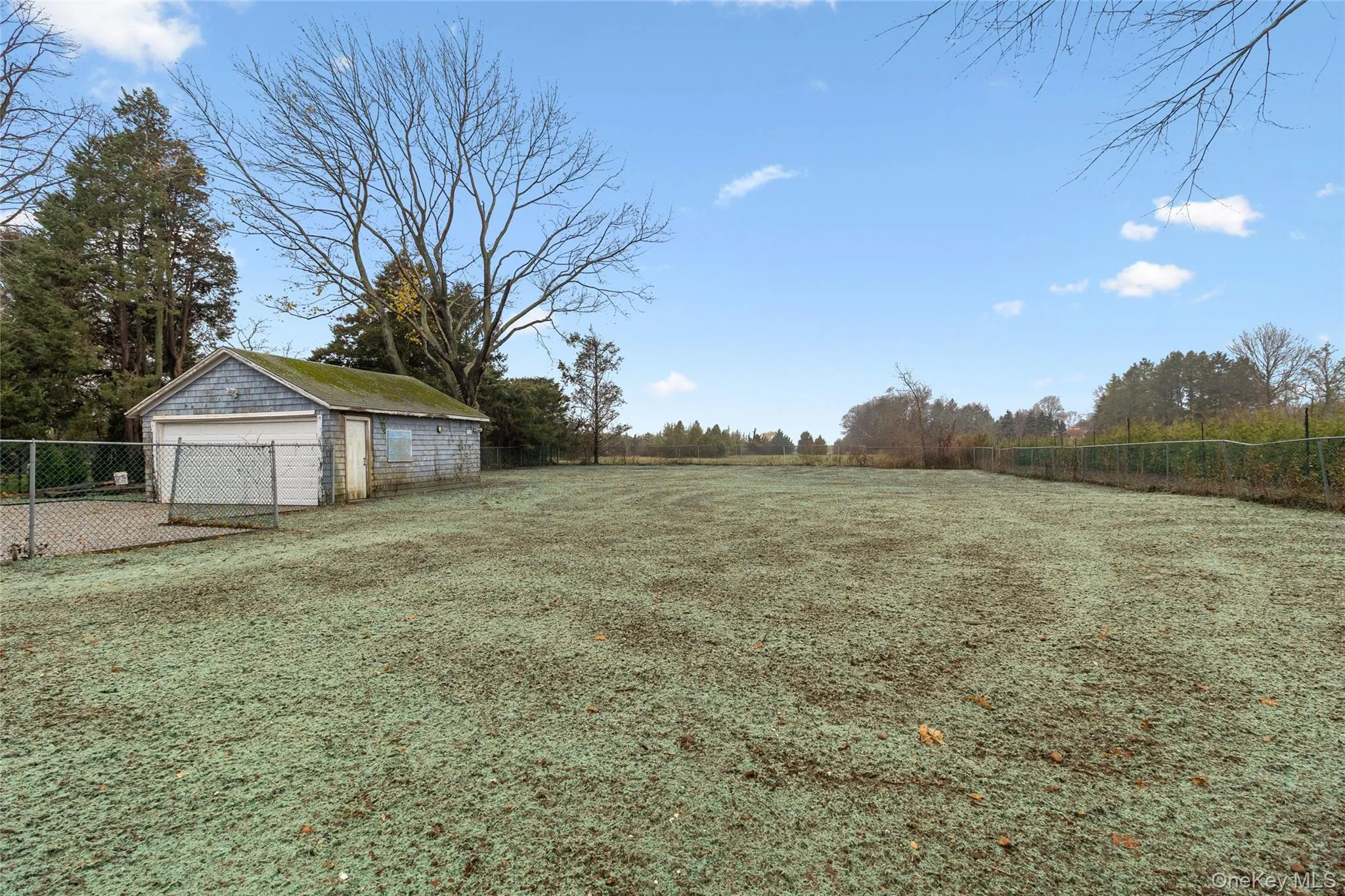 View of yard featuring an outbuilding and a detached garage View of yard featuring an outbuilding and a detached garage