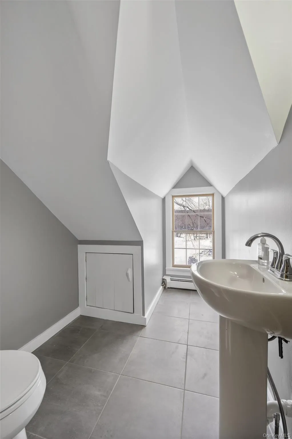 Half bath with vaulted ceiling and baseboard heating Half bath with vaulted ceiling and baseboard heating