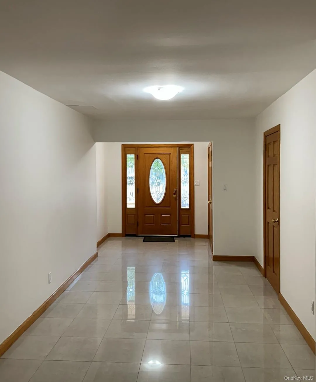 Entrance foyer with baseboards and light tile patterned floors Entrance foyer with baseboards and light tile patterned floors
