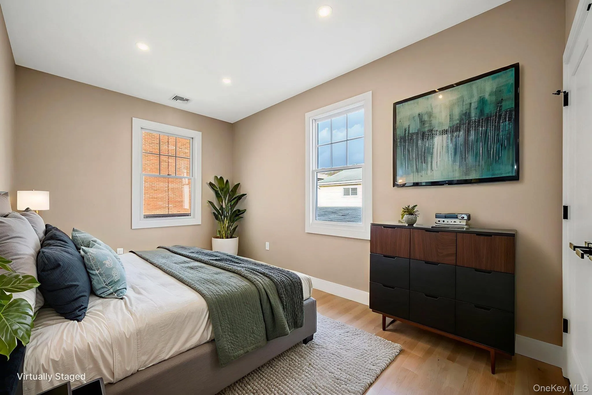 Bedroom with light wood-style floors and recessed lighting Bedroom with light wood-style floors and recessed lighting