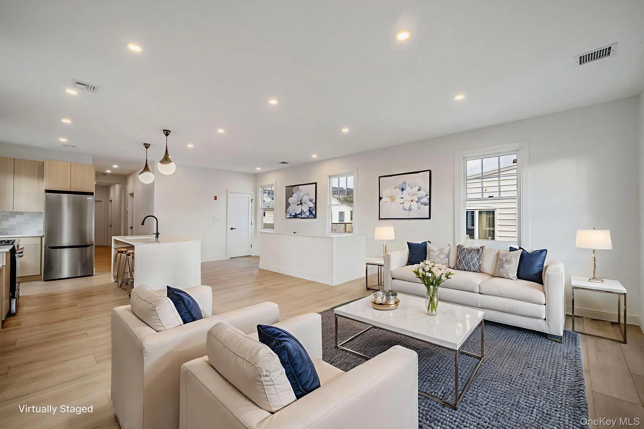 Living room with recessed lighting and light wood finished floors Living room with recessed lighting and light wood finished floors