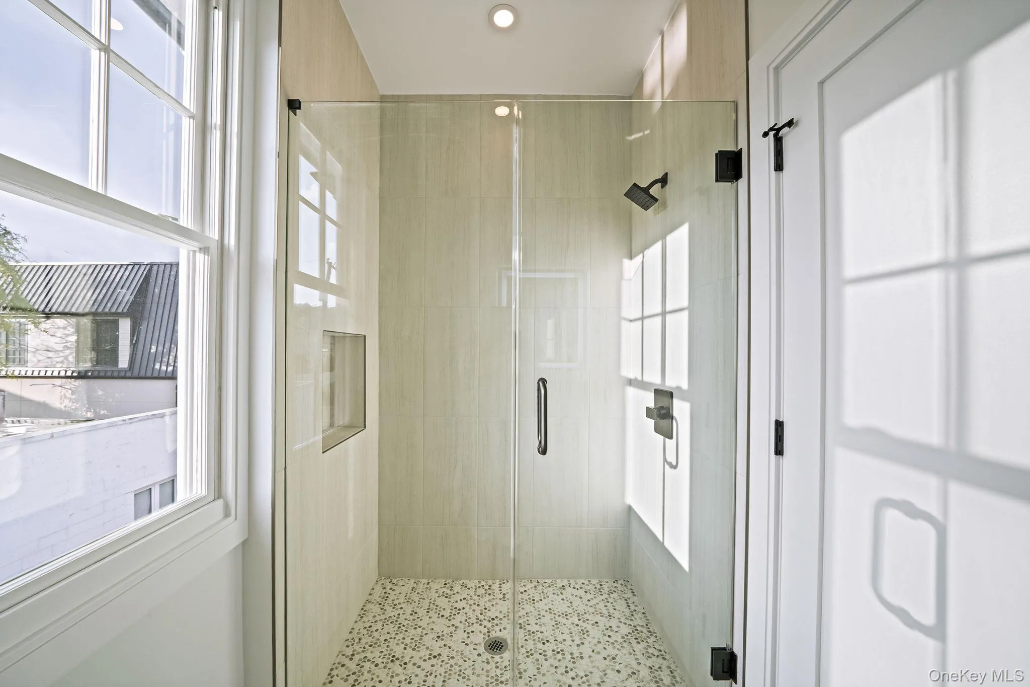 Bathroom with plenty of natural light and a shower stall Bathroom with plenty of natural light and a shower stall