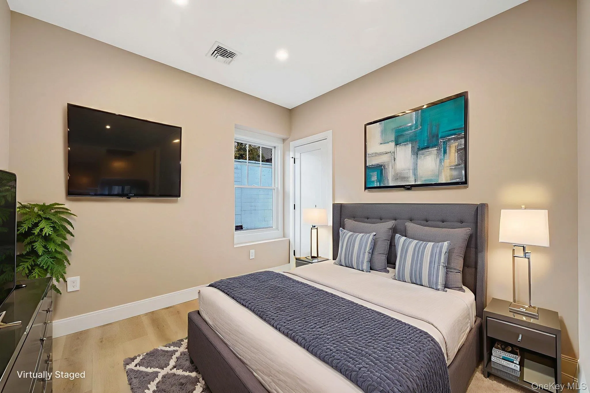Bedroom featuring baseboards and light wood-type flooring Bedroom featuring baseboards and light wood-type flooring