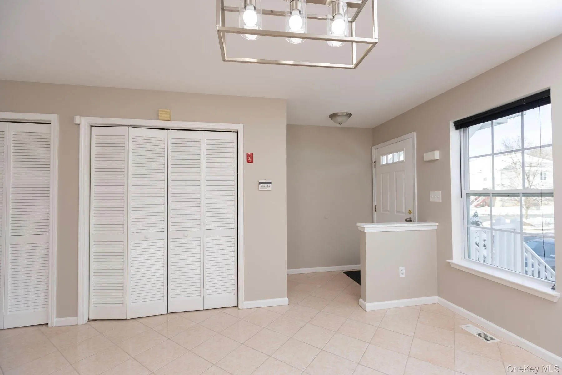 Foyer entrance with baseboards and light tile patterned flooring Foyer entrance with baseboards and light tile patterned flooring