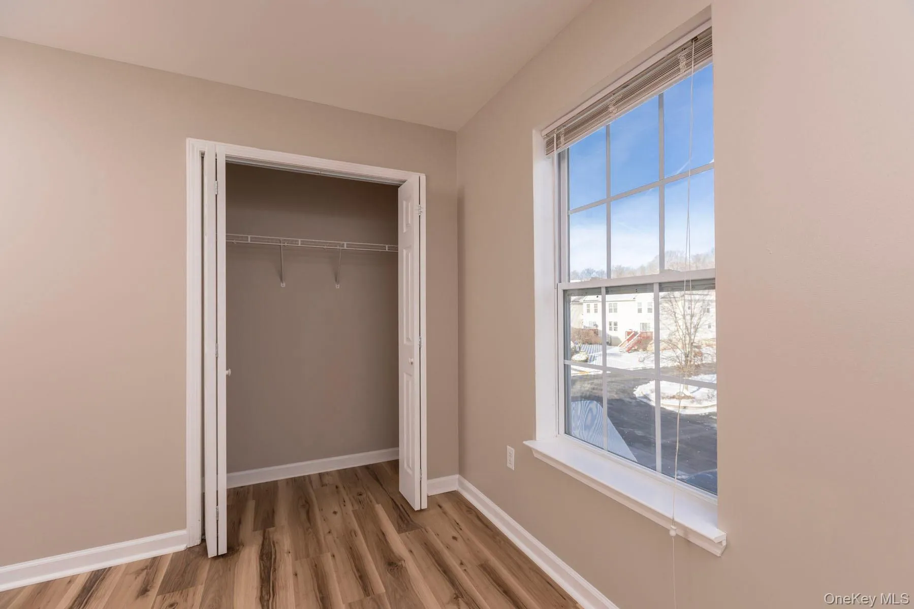 Unfurnished bedroom with light wood-style floors and a closet Unfurnished bedroom with light wood-style floors and a closet