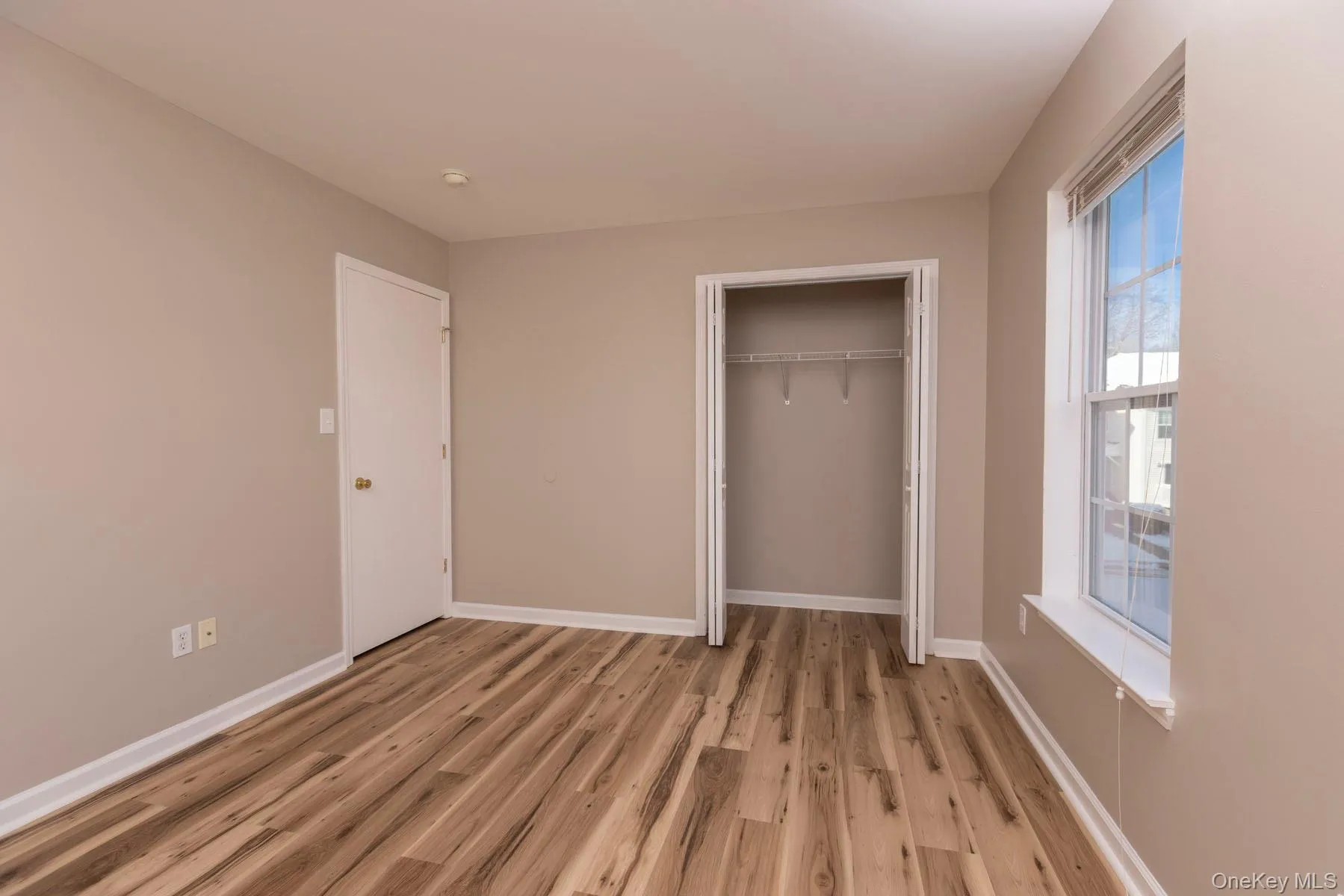 Unfurnished bedroom featuring light wood-style flooring and a closet Unfurnished bedroom featuring light wood-style flooring and a closet