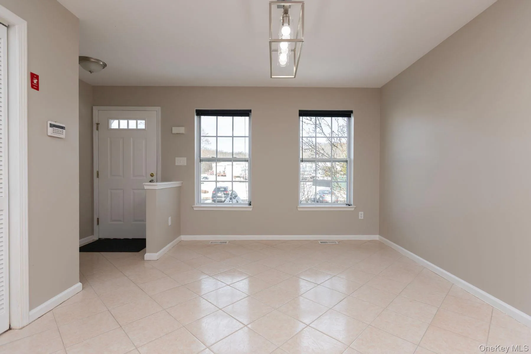 Entryway with baseboards and light tile patterned floors Entryway with baseboards and light tile patterned floors
