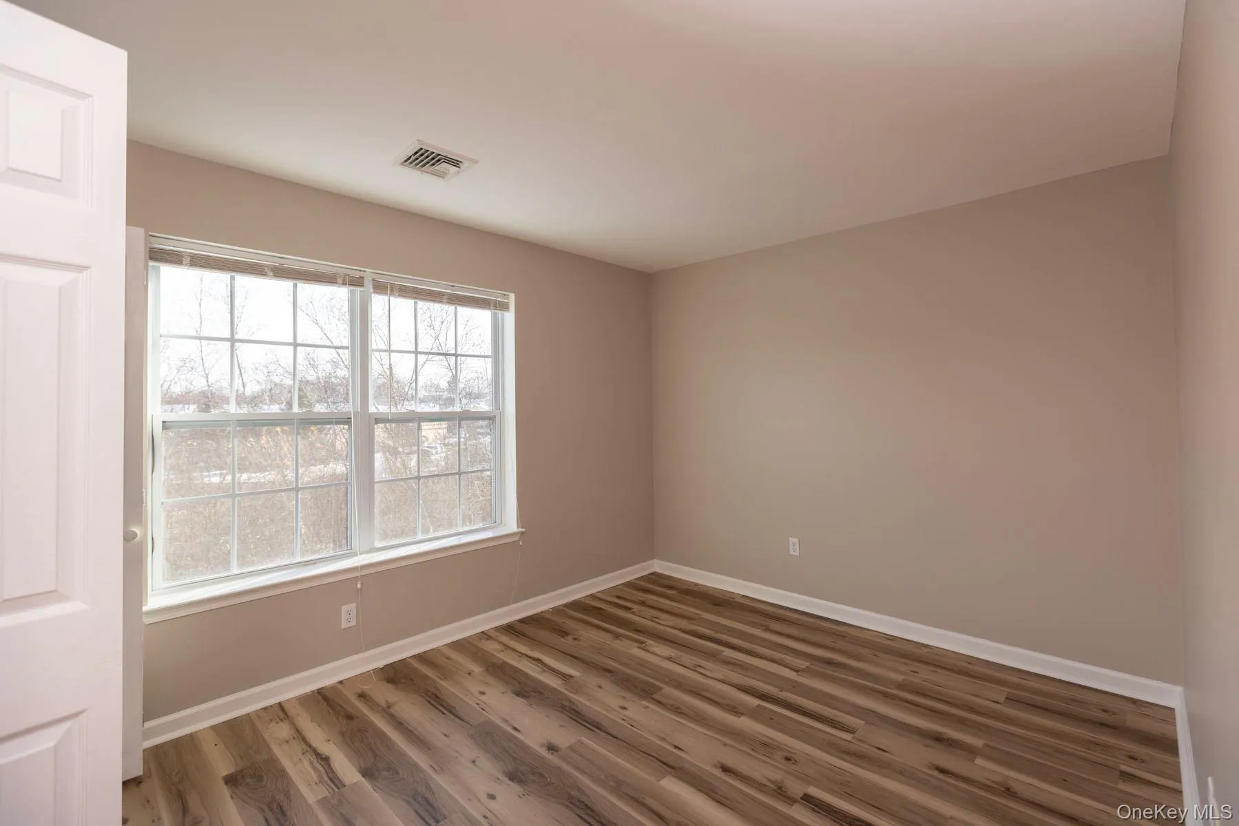 Unfurnished room featuring baseboards and wood finished floors Unfurnished room featuring baseboards and wood finished floors