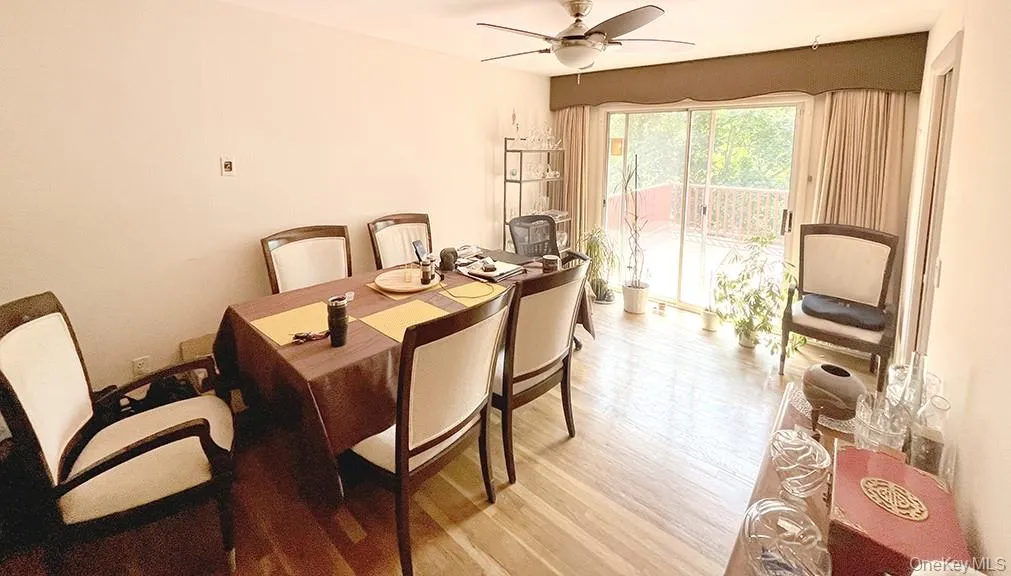 Dining room featuring light wood-style flooring and ceiling fan Dining room featuring light wood-style flooring and ceiling fan