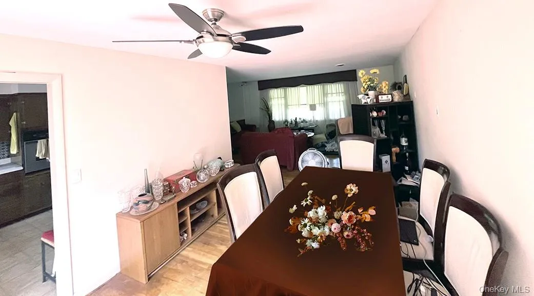 Dining space with light wood-type flooring and a ceiling fan Dining space with light wood-type flooring and a ceiling fan