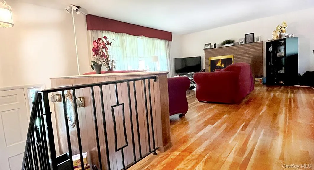 Living area with light wood-style floors and a brick fireplace Living area with light wood-style floors and a brick fireplace