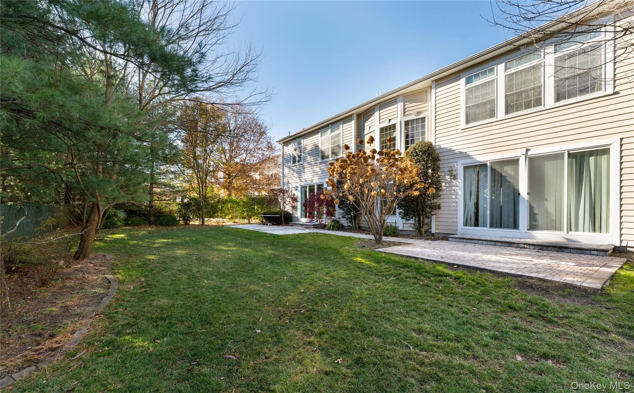 View of grassy yard featuring a patio View of grassy yard featuring a patio