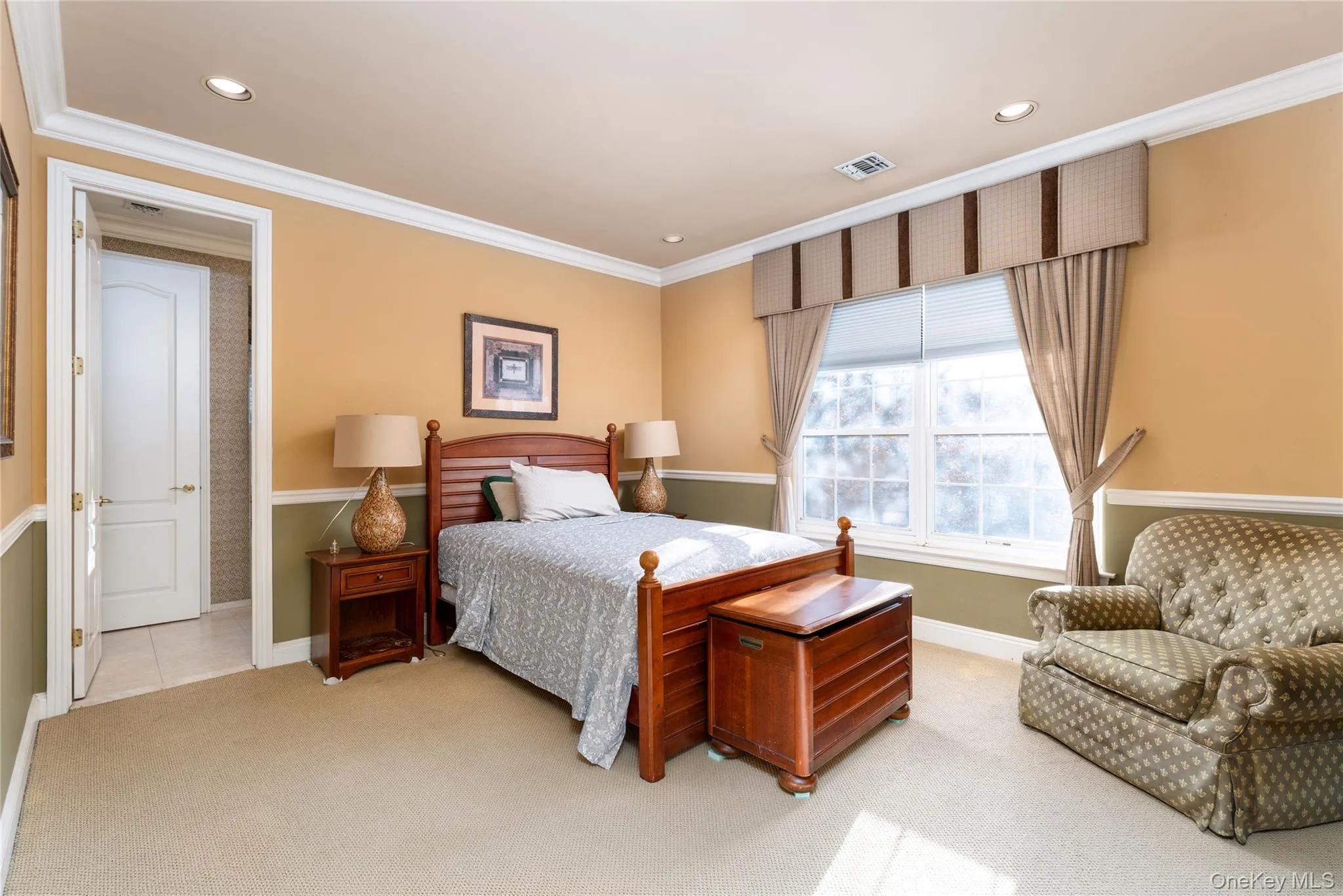 Bedroom with light colored carpet, crown molding, and recessed lighting Bedroom with light colored carpet, crown molding, and recessed lighting