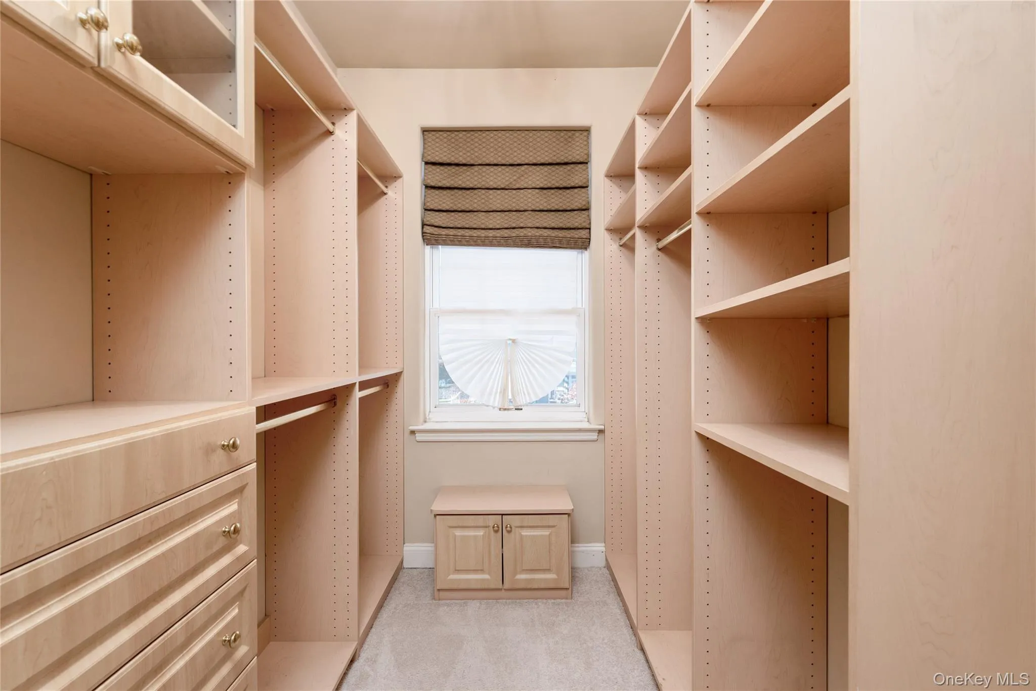 Spacious closet with light colored carpet Spacious closet with light colored carpet