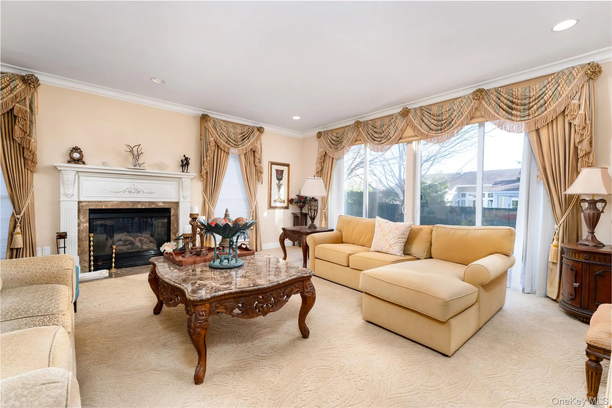 Living area with a fireplace, ornamental molding, carpet flooring, and recessed lighting Living area with a fireplace, ornamental molding, carpet flooring, and recessed lighting
