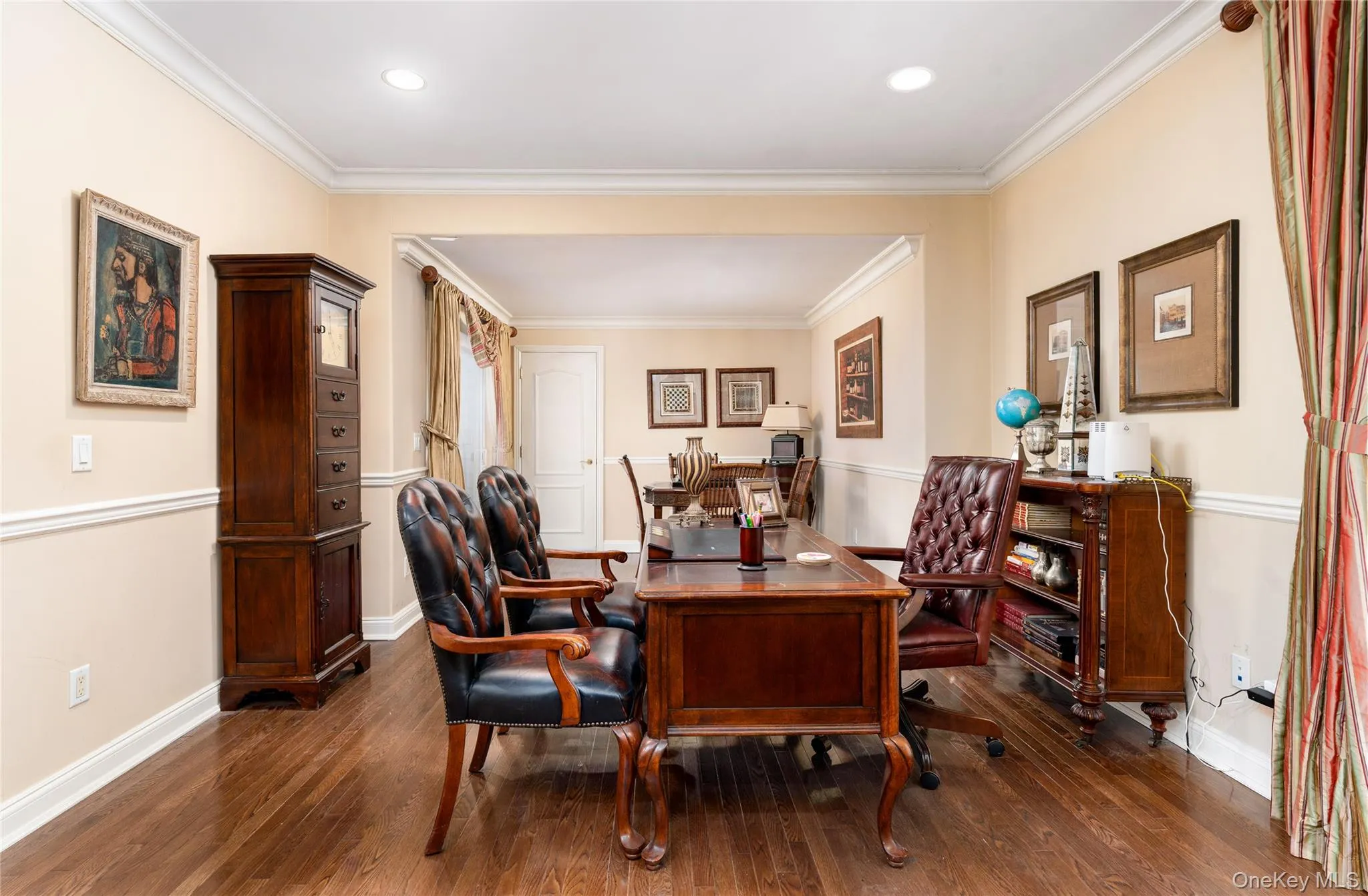 Dining room with an office area, dark wood-type flooring, ornamental molding, and recessed lighting Dining room with an office area, dark wood-type flooring, ornamental molding, and recessed lighting