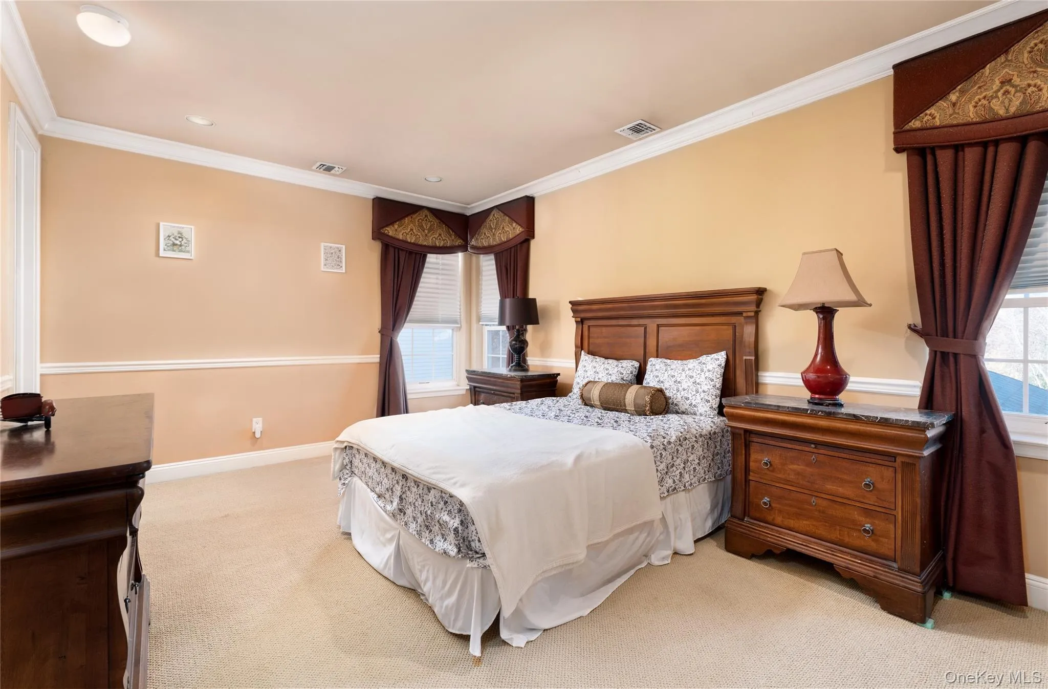 Bedroom with light carpet, crown molding, and recessed lighting Bedroom with light carpet, crown molding, and recessed lighting