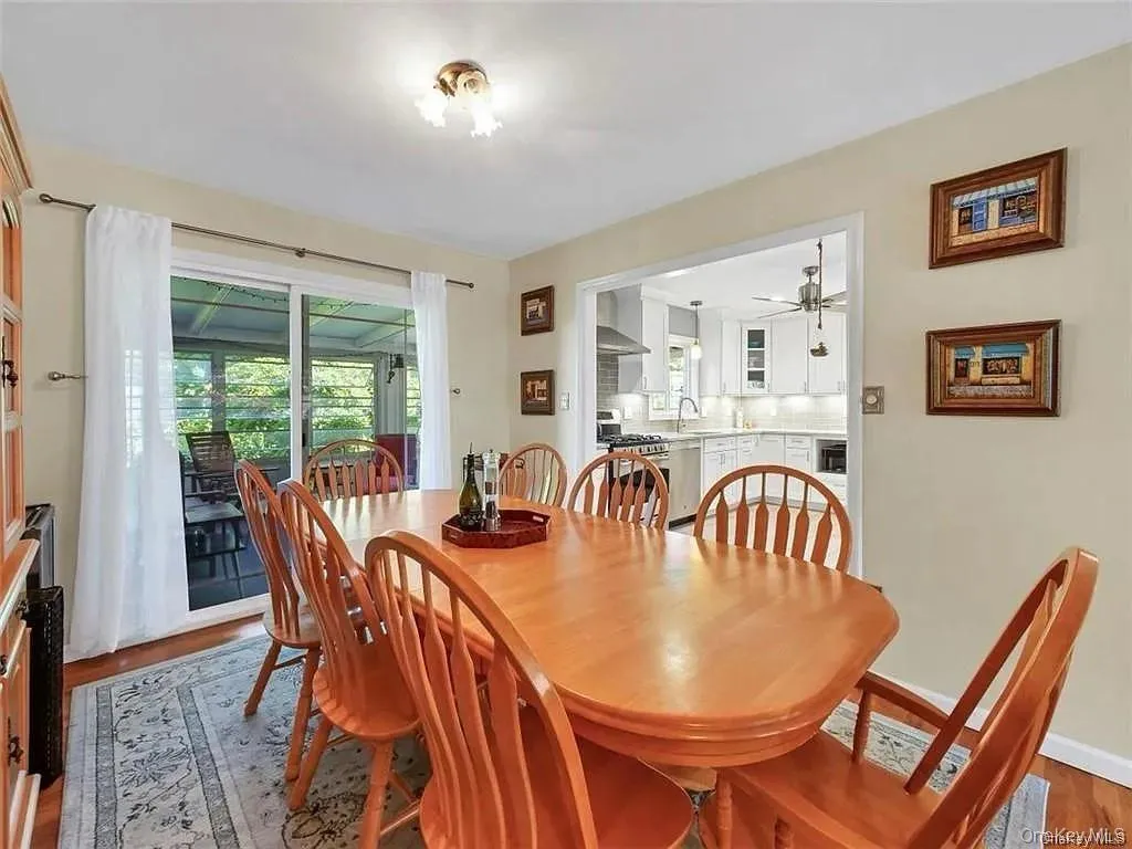 Dining room featuring wood-type flooring, sink, and ceiling fan Dining room featuring wood-type flooring, sink, and ceiling fan