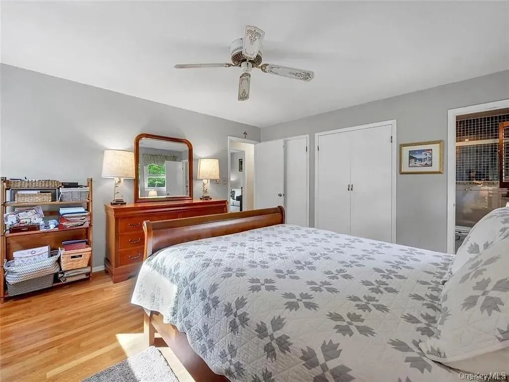 Bedroom featuring ceiling fan and light hardwood / wood-style floors Bedroom featuring ceiling fan and light hardwood / wood-style floors