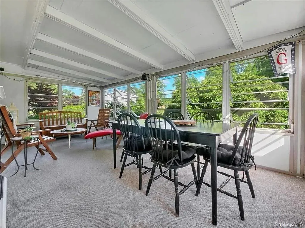 Sunroom / solarium featuring beamed ceiling Sunroom / solarium featuring beamed ceiling