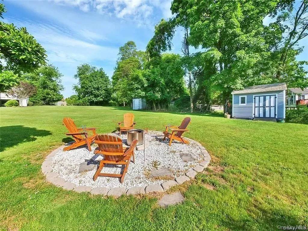 View of yard with a fire pit and a storage shed View of yard with a fire pit and a storage shed