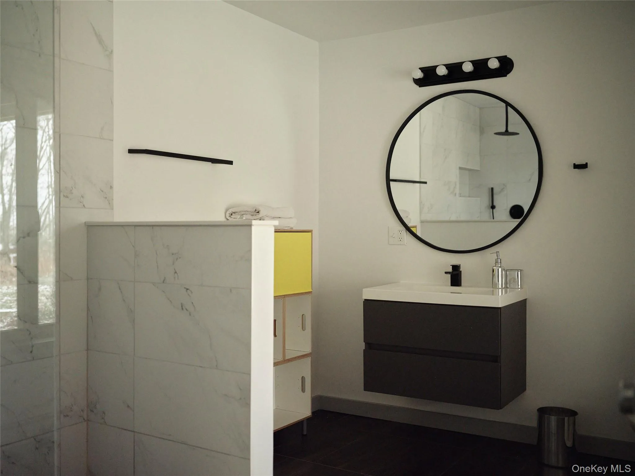 Full bath featuring vanity and a marble finish shower Full bath featuring vanity and a marble finish shower