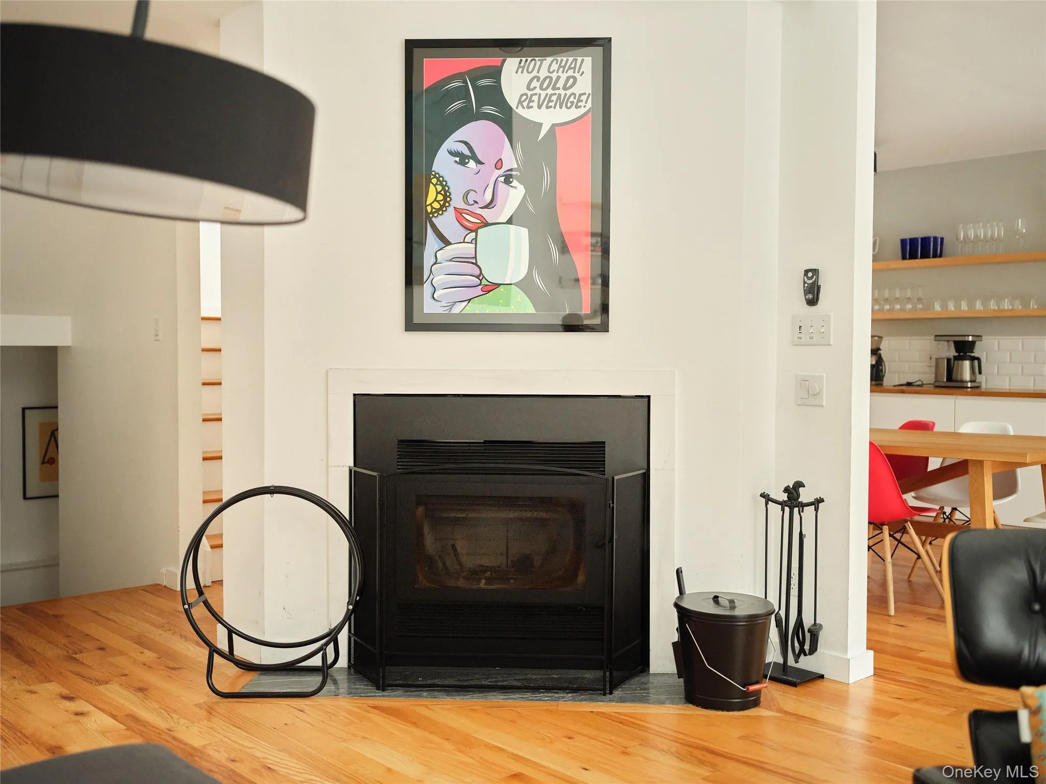 Detailed view of a fireplace with flush hearth and wood finished floors Detailed view of a fireplace with flush hearth and wood finished floors