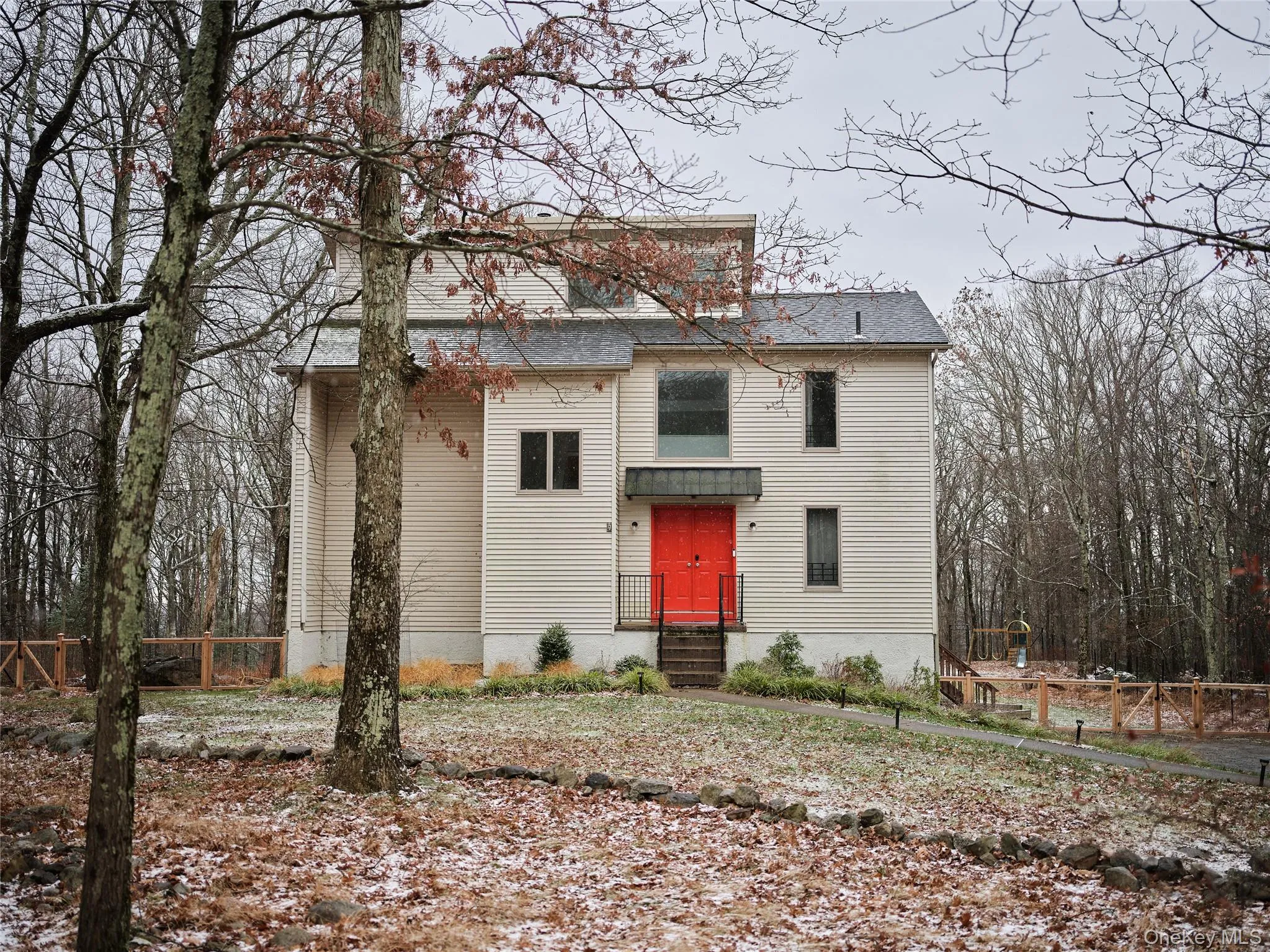 View of front facade featuring a shingled roof View of front facade featuring a shingled roof