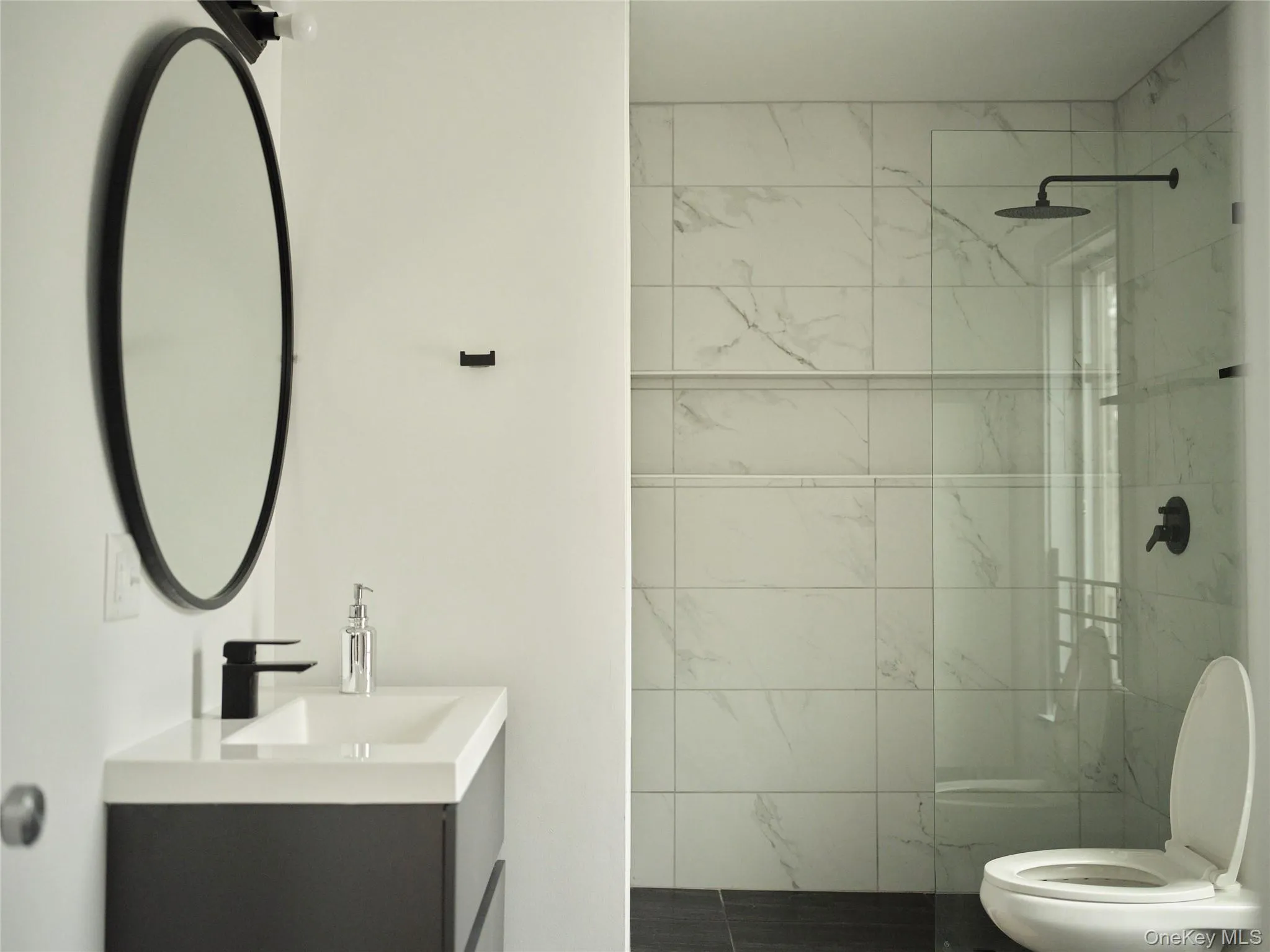 Bathroom with vanity and a marble finish shower Bathroom with vanity and a marble finish shower