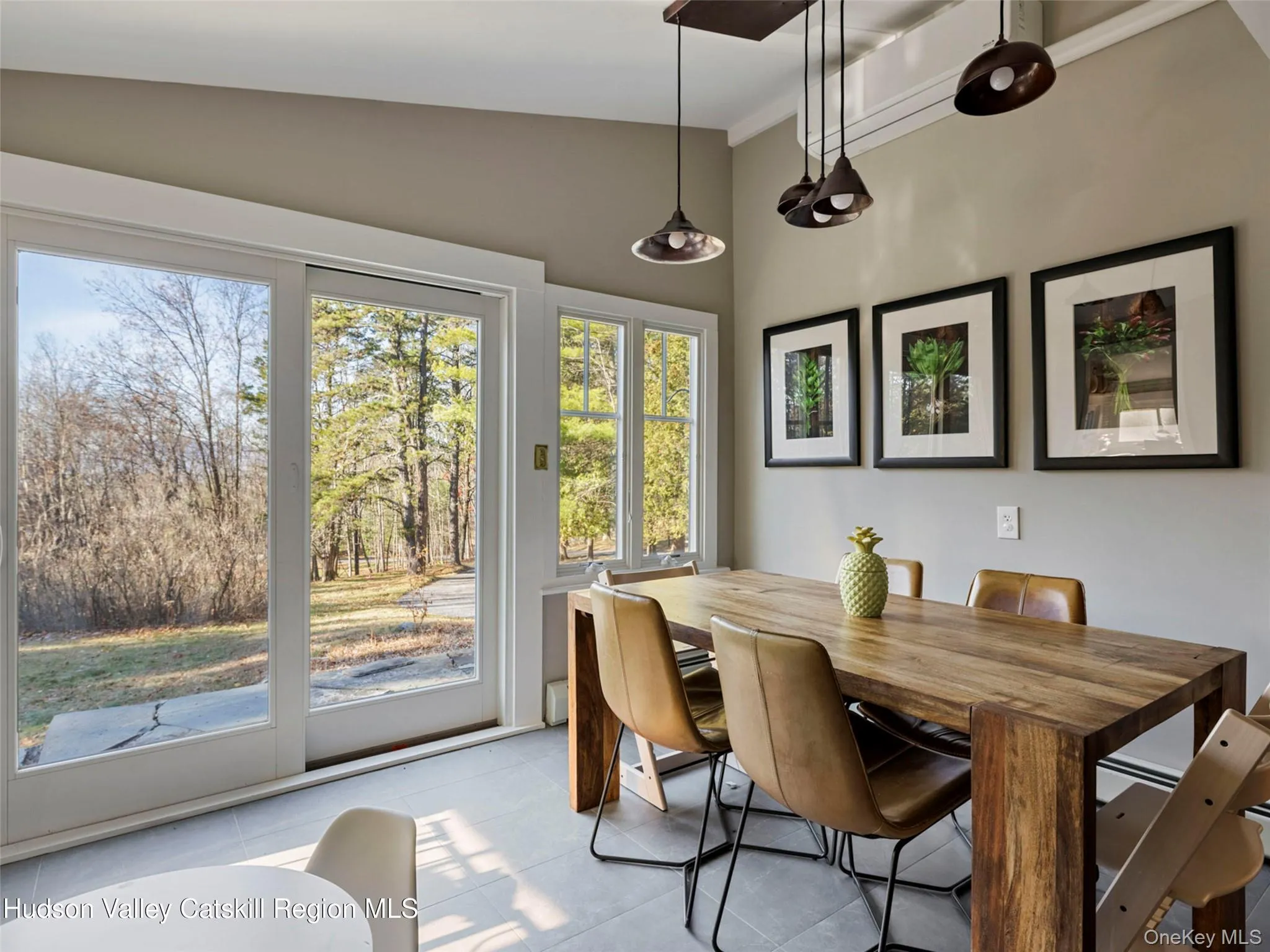 Dining room featuring lofted ceiling and light tile patterned floors Dining room featuring lofted ceiling and light tile patterned floors