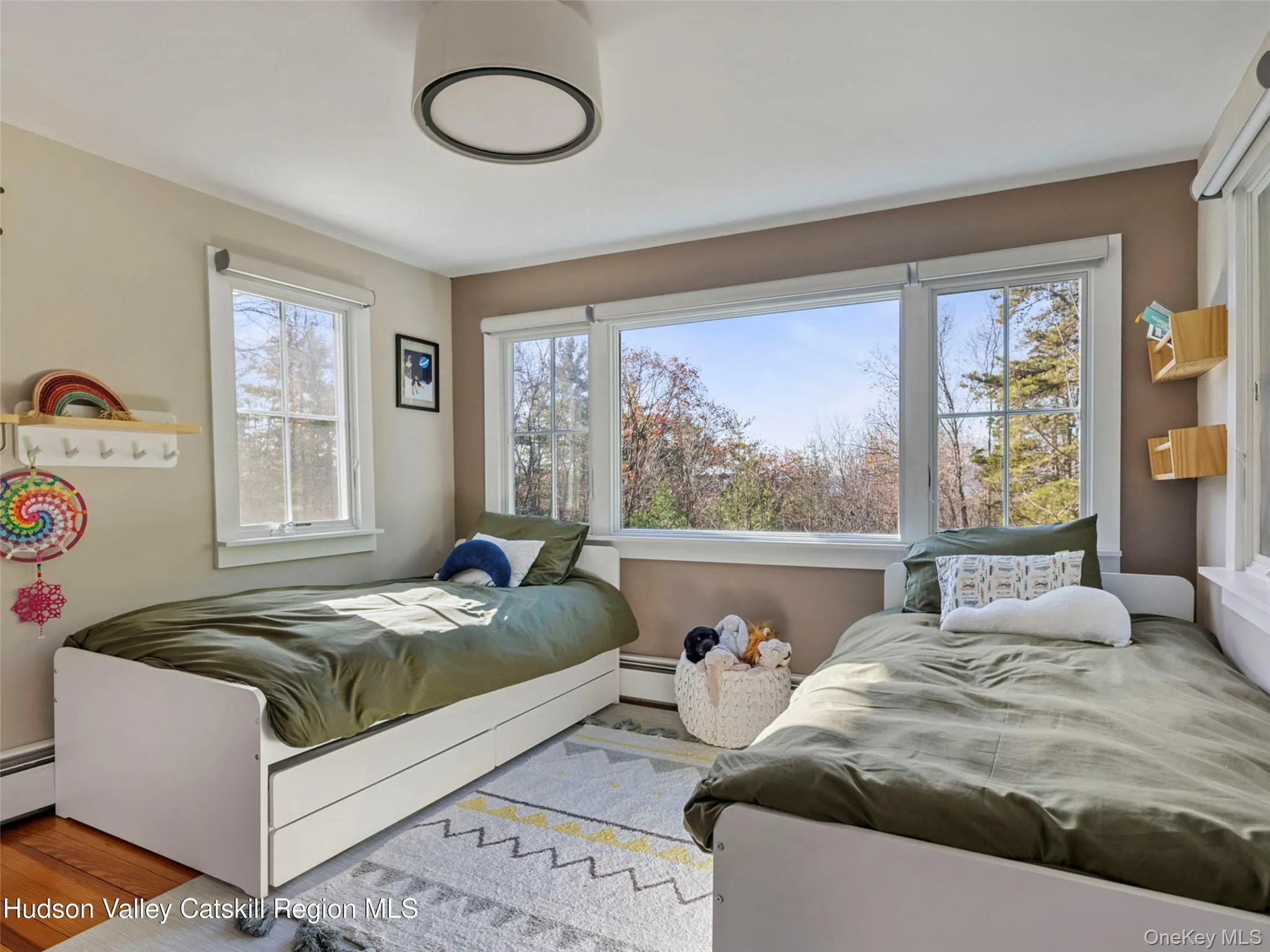 Bedroom featuring a baseboard heating unit and wood finished floors Bedroom featuring a baseboard heating unit and wood finished floors