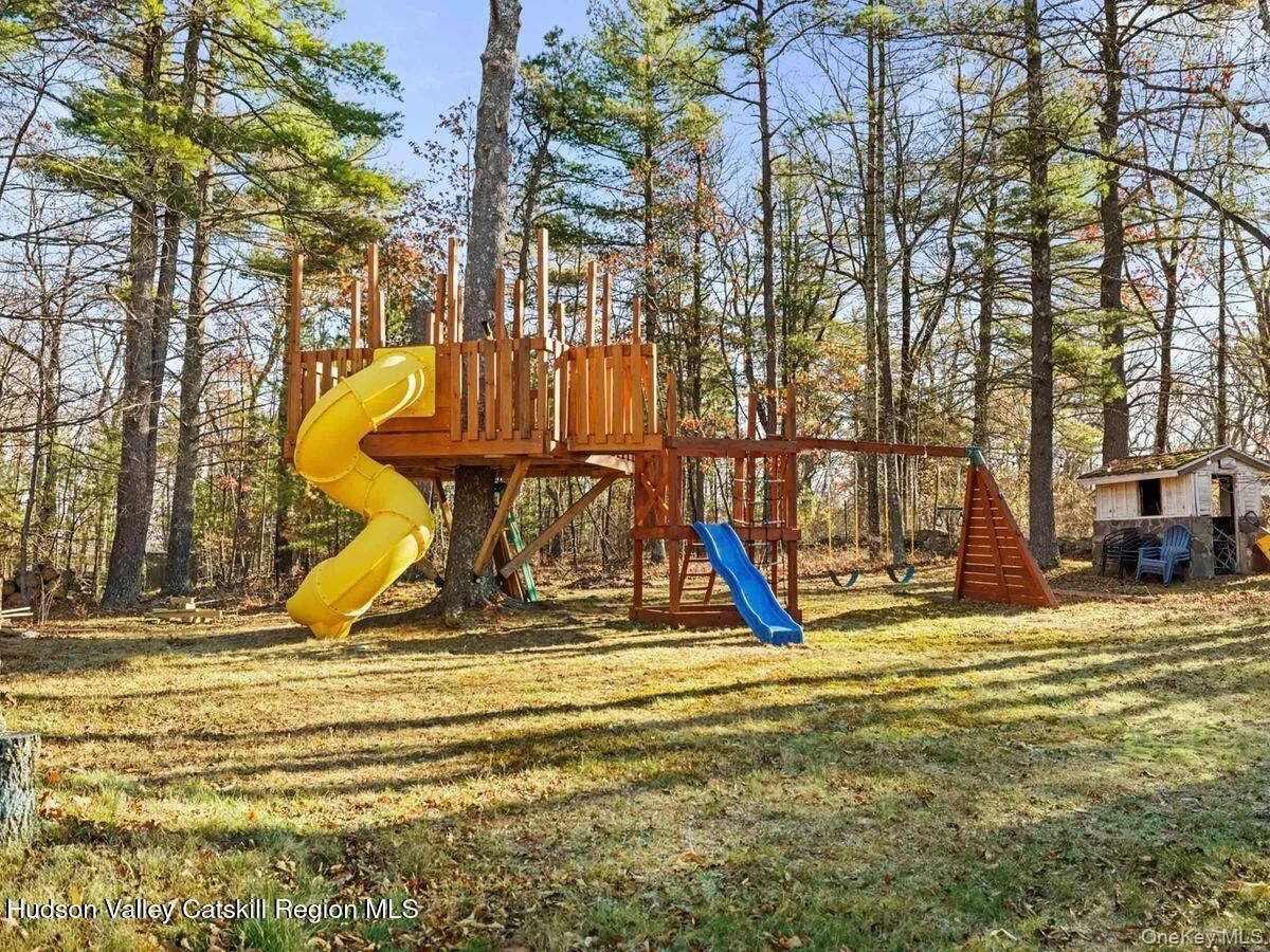 Community play area featuring a lawn Community play area featuring a lawn