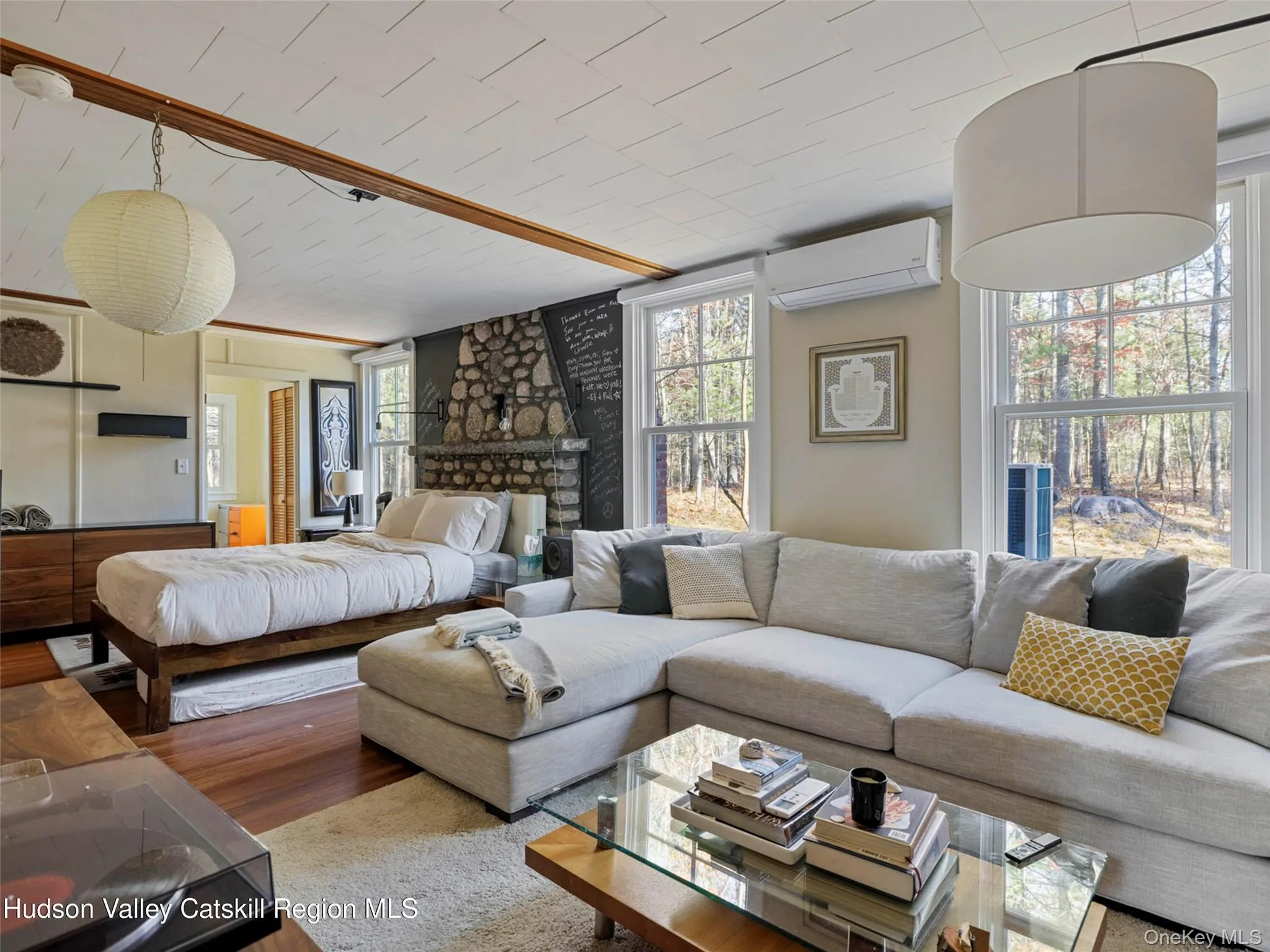 Bedroom with wood finished floors and a wall unit AC Bedroom with wood finished floors and a wall unit AC