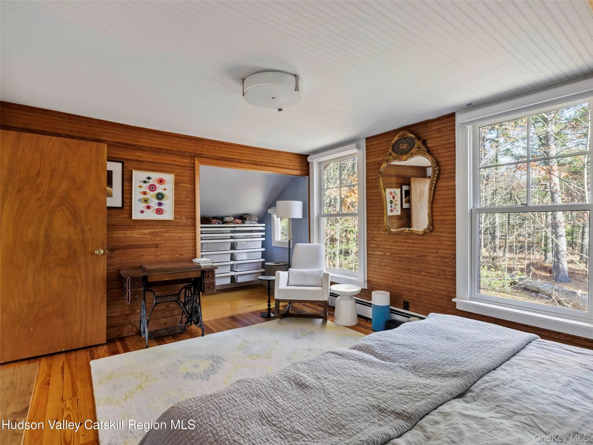 Bedroom featuring wood walls and wood finished floors Bedroom featuring wood walls and wood finished floors